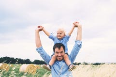 Happy father and son on nature at summer day. Family outdoors stock images Happy father and son on nature at summer day. Family outdoors stock images