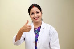 Happy female doctor making thumbs up gesture stock photos Happy female doctor making thumbs up gesture stock photos