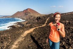 Happy fitness woman on hiking trail eating apple royalty free stock photo Happy fitness woman on hiking trail eating apple royalty free stock photo