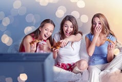 Happy friends eating pizza and watching tv at home Royalty Free Stock Images Happy friends eating pizza and watching tv at home Royalty Free Stock Images
