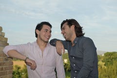 Happy gay couple smiling in a beautiful place stock photography Happy gay couple smiling in a beautiful place stock photography