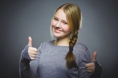 Happy girl showing thubs up. Closeup Portrait child smiling isolated on grey royalty free stock image Happy girl showing thubs up. Closeup Portrait child smiling isolated on grey royalty free stock image