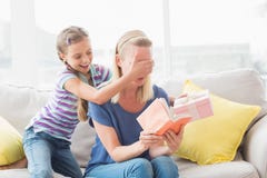 Happy girl surprising her mother with gift at home royalty free stock images Happy girl surprising her mother with gift at home royalty free stock images