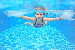 Happy girl swims in pool underwater, active kid swimming and having fun royalty free stock photography Happy girl swims in pool underwater, active kid swimming and having fun royalty free stock photography