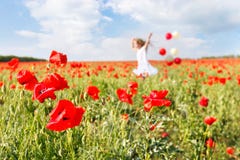 Happy Girl With Colorful Balloons In Poppies Royalty Free Stock Photo