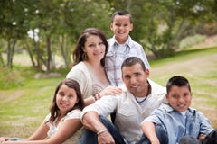 Happy Hispanic Family In The Park Stock Photo