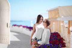 Happy honeymoon of a fall-in-love couple is walking outdoors. Beautiful girl hugging her boyfriend on a summer holiday. royalty free stock image Happy honeymoon of a fall-in-love couple is walking outdoors. Beautiful girl hugging her boyfriend on a summer holiday. royalty free stock image