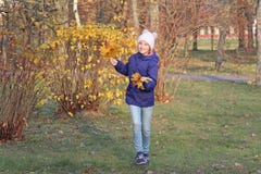 Happy Kid Girl In A Warm Hat. Autumn, Walk In The Park. Royalty Free Stock Photo Happy Kid Girl In A Warm Hat. Autumn, Walk In The Park. Royalty Free Stock Photo