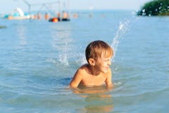 Happy Kid On Summer Vacations. Cute Boy Swimming In Water. Kid Having Fun At The Beach Royalty Free Stock Image Happy Kid On Summer Vacations. Cute Boy Swimming In Water. Kid Having Fun At The Beach Royalty Free Stock Image