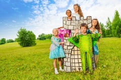 Happy kids in theatric costumes play around tower stock images Happy kids in theatric costumes play around tower stock images