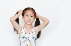 Happy of little Asian child girl holding pigtail on white background. Portrait smiling kid with two pigtails stock photo Happy of little Asian child girl holding pigtail on white background. Portrait smiling kid with two pigtails stock photo