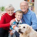 Happy little boy with his elderly grandparents Stock Image Happy little boy with his elderly grandparents Stock Image