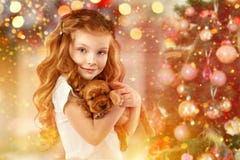 Happy little girl and dog beside Christmas tree. New year 2018. Holiday concept, Christmas, New year background. stock images Happy little girl and dog beside Christmas tree. New year 2018. Holiday concept, Christmas, New year background. stock images