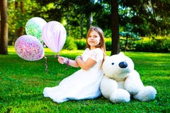 Happy little girl with many balloons and a teddy bear stock photos Happy little girl with many balloons and a teddy bear stock photos