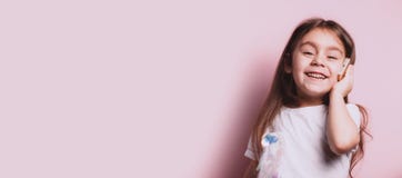 Happy little girl talking on telephone on pink background stock photo Happy little girl talking on telephone on pink background stock photo
