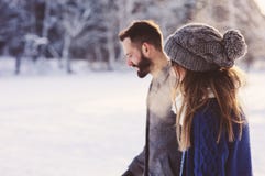 Happy loving couple walking in snowy winter forest, spending christmas vacation together. Outdoor seasonal activities Royalty Free Stock Photos Happy loving couple walking in snowy winter forest, spending christmas vacation together. Outdoor seasonal activities Royalty Free Stock Photos