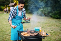 Happy male preparing bbq meat Royalty Free Stock Image Happy male preparing bbq meat Royalty Free Stock Image