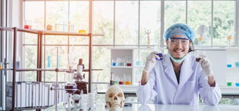 A happy male scientist showing the successful results of his experiment in a science lab royalty free stock photo A happy male scientist showing the successful results of his experiment in a science lab royalty free stock photo