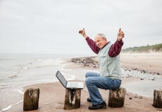 Happy man with a laptop on the beach royalty free stock photo Happy man with a laptop on the beach royalty free stock photo