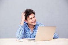 Happy man sitting at the table with laptop royalty free stock photos Happy man sitting at the table with laptop royalty free stock photos
