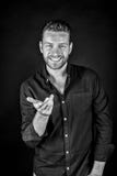 Happy man smiling with hand gesture in shirt stock photography Happy man smiling with hand gesture in shirt stock photography