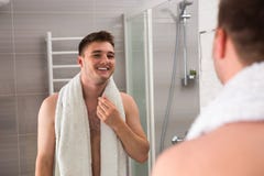 Happy Man Smiling, Holding Towel On His Shoulders After Washing Royalty Free Stock Photo