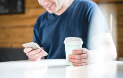 Happy man using smartphone in cafe or home. stock photo Happy man using smartphone in cafe or home. stock photo