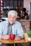 Happy Mature Man in Coffee House stock image Happy Mature Man in Coffee House stock image