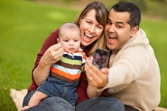 Happy Mixed Race Parents And Baby Boy With Camera Royalty Free Stock Photos Happy Mixed Race Parents And Baby Boy With Camera Royalty Free Stock Photos