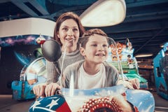 Happy mom and son on toy motorcycle royalty free stock photos Happy mom and son on toy motorcycle royalty free stock photos