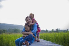 Happy Mother and her child play outdoors having fun, Green rice field back ground stock photo Happy Mother and her child play outdoors having fun, Green rice field back ground stock photo