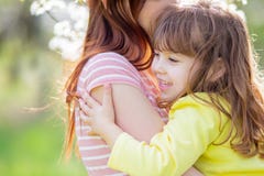 Mother and little daughter with bunny ears standing under a blooming cherry tree at sunny spring Easter day stock photo Mother and little daughter with bunny ears standing under a blooming cherry tree at sunny spring Easter day stock photo