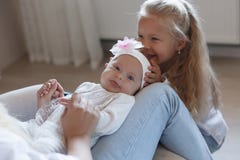 Happy mother with older and little daughter at home royalty free stock photography Happy mother with older and little daughter at home royalty free stock photography