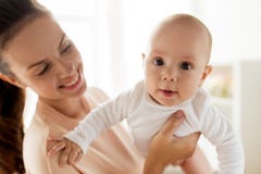 Happy mother playing with little baby boy at home stock image Happy mother playing with little baby boy at home stock image