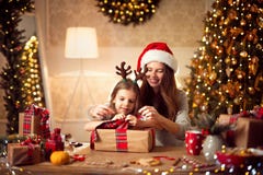 A happy family mother and child pack Christmas gifts royalty free stock images A happy family mother and child pack Christmas gifts royalty free stock images