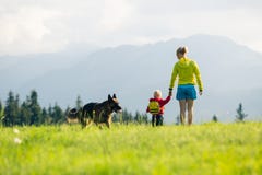 Happy Mother With Baby Boy Walking A Dog Royalty Free Stock Images