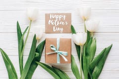 happy mothers day text sign on greeting card with stylish present box and tulips on white wooden rustic background. flat lay mock royalty free stock images happy mothers day text sign on greeting card with stylish present box and tulips on white wooden rustic background. flat lay mock royalty free stock images