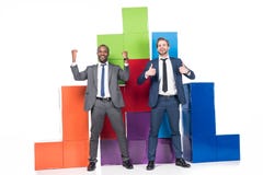 happy multiethnic businessmen standing near colorful blocks royalty free stock image happy multiethnic businessmen standing near colorful blocks royalty free stock image