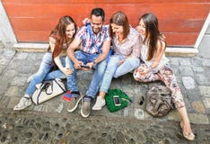 Happy multiracial best friends having fun using mobile smart phone Royalty Free Stock Image Happy multiracial best friends having fun using mobile smart phone Royalty Free Stock Image