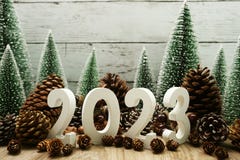 Happy New Year 2023 Decoration With Christmas Tree And Pine Cones On Wooden Background Royalty Free Stock Image