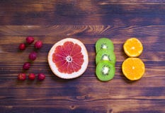 Happy new year 2018 made of fruit and berries on wooden background. Stock Photo Happy new year 2018 made of fruit and berries on wooden background. Stock Photo