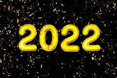 2022 Happy New Year numbers text, confetti on black background. Christmas party greeting decor