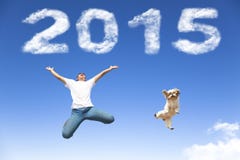 Happy new year 2015.young man and dog jumping Royalty Free Stock Photo Happy new year 2015.young man and dog jumping Royalty Free Stock Photo
