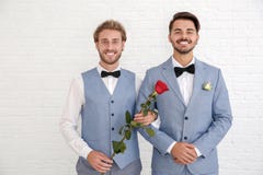 Happy newlywed gay couple with flower royalty free stock images Happy newlywed gay couple with flower royalty free stock images