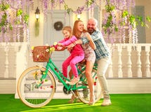Happy parents with a child, daughter, learn to ride a bike, family lifestyle summer vacations at home royalty free stock images Happy parents with a child, daughter, learn to ride a bike, family lifestyle summer vacations at home royalty free stock images