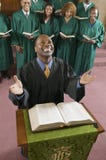 Happy preacher with Bible at church altar looking up high angle view stock photo Happy preacher with Bible at church altar looking up high angle view stock photo