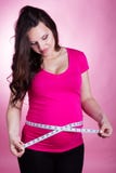 Happy pregnant girl with tape measure stock photo Happy pregnant girl with tape measure stock photo