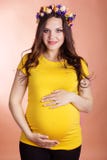 Happy pregnant girl with wreath of flowers stock photography Happy pregnant girl with wreath of flowers stock photography