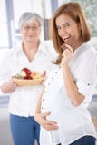 Happy pregnant woman eating chocolate royalty free stock photos Happy pregnant woman eating chocolate royalty free stock photos