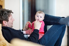 Happy proud young father having fun with newborn baby daughter, family portrait together. Dad with baby girl, love. New royalty free stock photos Happy proud young father having fun with newborn baby daughter, family portrait together. Dad with baby girl, love. New royalty free stock photos
